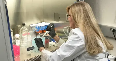 Tetyana L. Vasylyeva, M.D., Ph.D. working in a lab