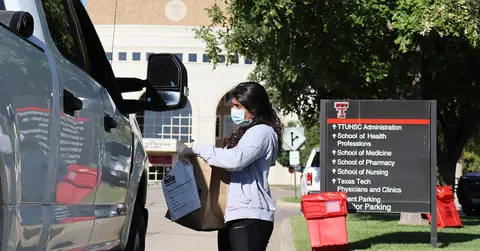 woman obtaining medication from a vehicle at the fall medication cleaout in Amarillo