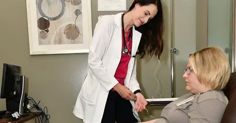 Nichole Campbell, APRN, NP-C, with a patient.