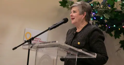 Woman speaks at a podium.