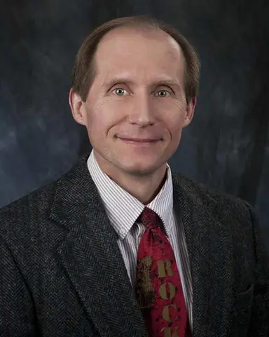 Male TTUHSC regional dean wears a suit and tie.