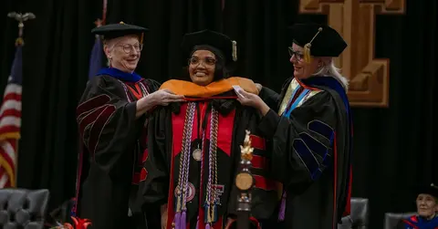 TTUHSC school of nursing student getting hooded for graduation
