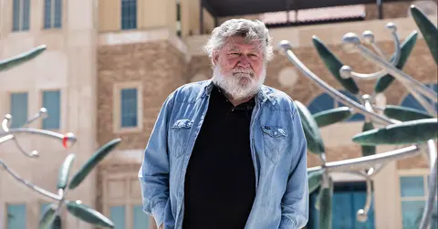 James Surls, artist for complete fragment stands in front 