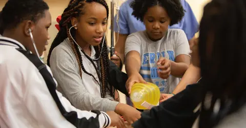 Students try using stethoscopes