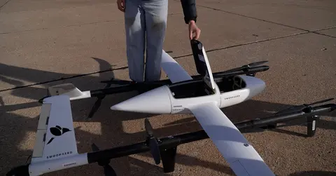 person standing next to Matador drone