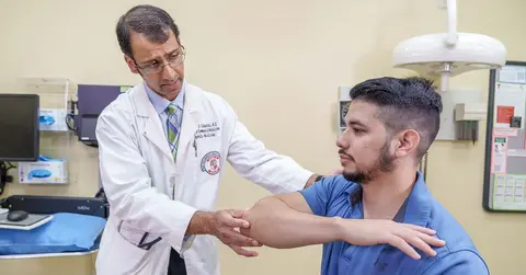 David Edwards, M.D., performing an exam with a patient