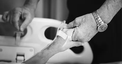 Patient's hand being held 