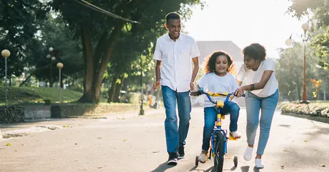 Family rides bike together