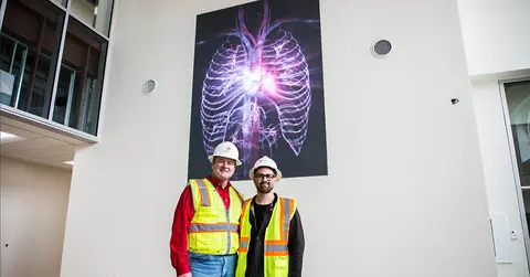 Ted Mitchell, M.D., and artist stand in front of 