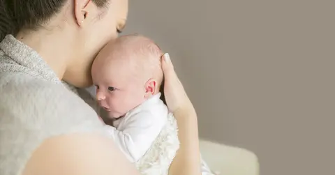 Woman holding newborn baby