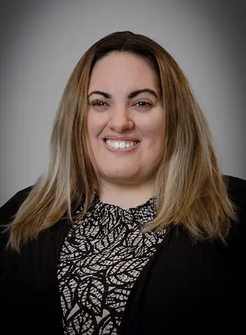 Woman smiles for a headshot.