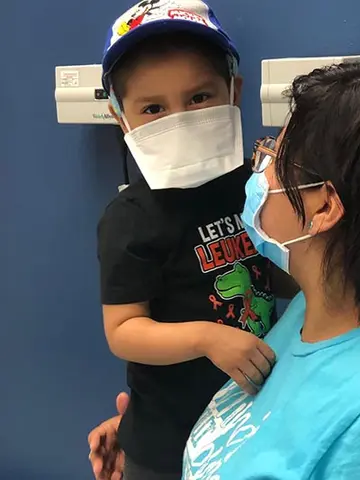 Logan, held by his mom