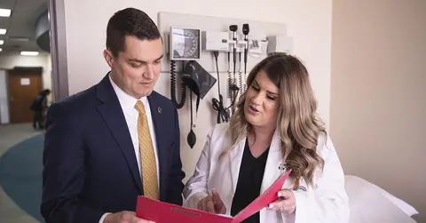 two health professionals looking at a file