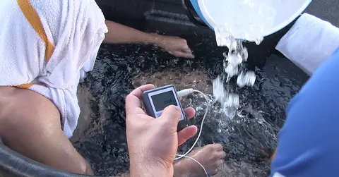 athletic trainers giving a patient an ice bath