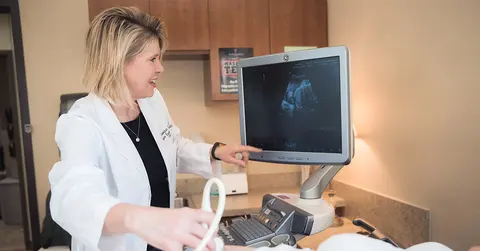 Jennifer Phy, D.O., looking at an ultrasound