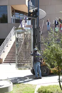 A forklift was used to move the five brushed aluminum sculptures into place.