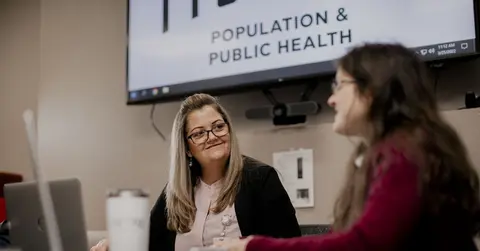 public health professionals talking in a conference room