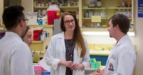 Rambaugh with students in lab