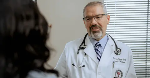 Rodney Young, M.D., speaking to a patient