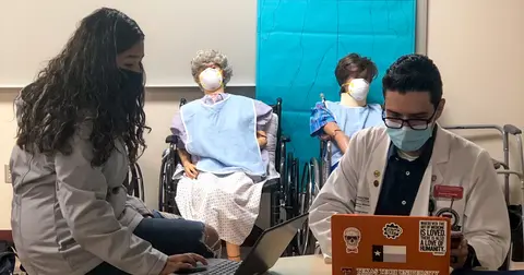 student and rural health mentor sitting at a table