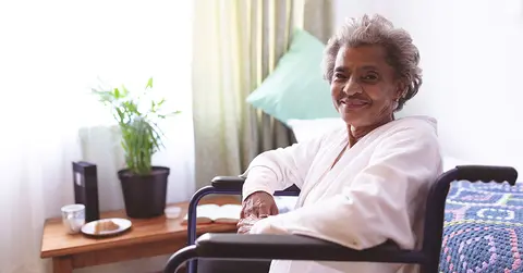 senior woman in a wheelchair by a window