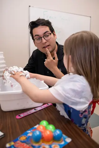 TTUHSC speech language pathology student interacting with a patient during an activity.