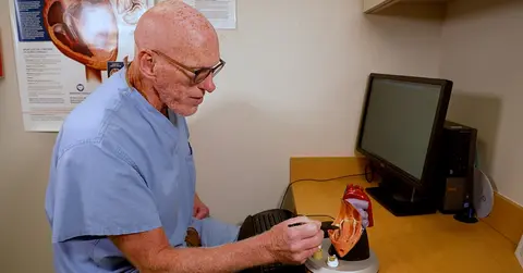 Scott Shurmur, M.D., examines a model of the heart