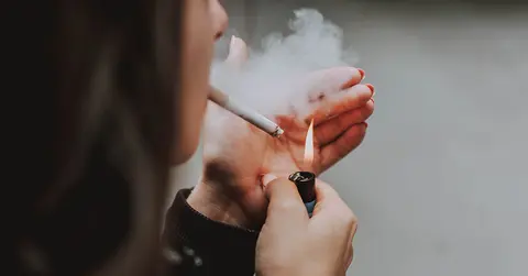 woman lighting a cigarette