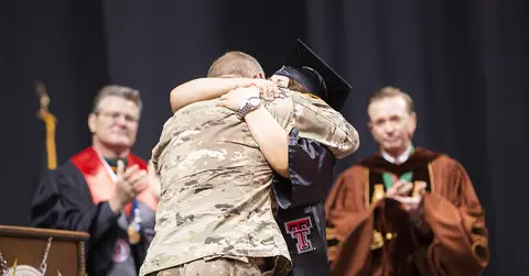 Nursing student hugs her father