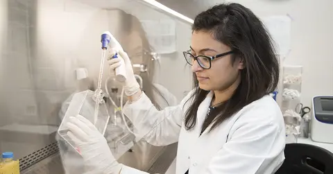 Student tests sample in labratory