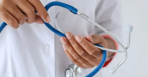 hands holding a stethoscope 