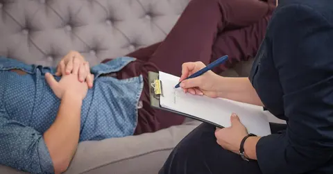person lying on couch in therapy session