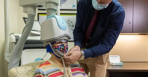 TMS equipment on patient Dana Bear