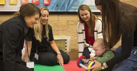 health care professionals caring for a baby with Down syndrome