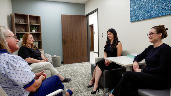 Second candid photo of Grady, Winkelman, Jennings, Noble in an office discussing the impact of Endometriosis.