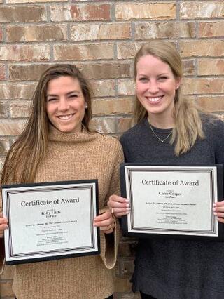 Kelly Little and Chloe Cooper accepting certificates