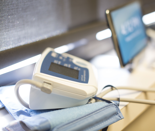 blood pressure monitor on counter next to computer monitor