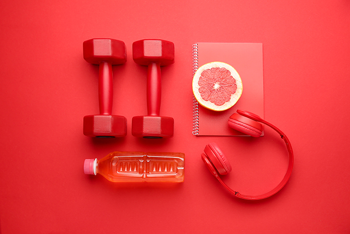 red background with water, weights and grapefruit